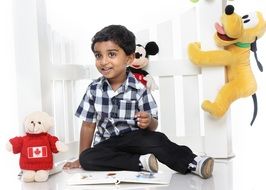 portrait of happy playing child boy with toys