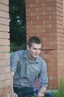 portrait of Teen beside brick wall