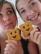 girls with emoticon cookies