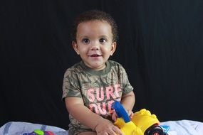 photo of baby with toys