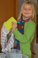 girl lays out containers