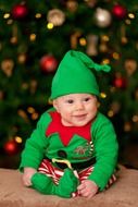 baby in green New Year suit