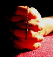 hands in prayer with beads