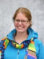 young woman with glasses smiling