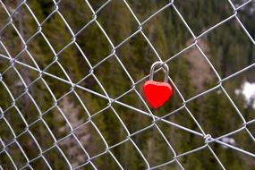 Red Love padlock on a fence