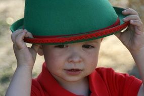 little boy in green hat