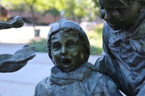 Surprised child, bronze statue