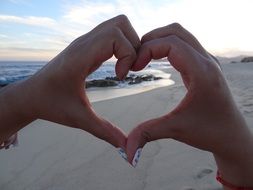 heart hands on the beach