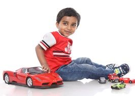 happy boy playing with toy sport car