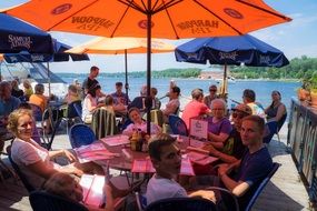 people on the summer terrace in the restaurant on Lake Champlain