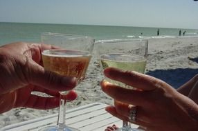 glasses of champagne in the hands of the newlyweds