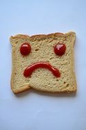 Smiley face made from the ketchup on the bread