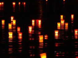 candles on the water at night