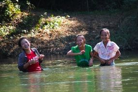 smiling girls in the water of the river