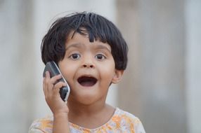Child speaking on a phone