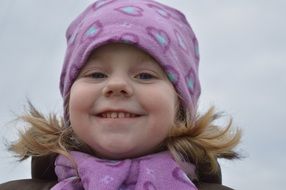 laughting girl in purple hat