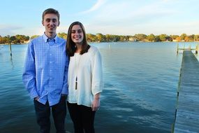 brother and sister posing at the pier