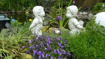 romantic sculpture of two little children in the garden