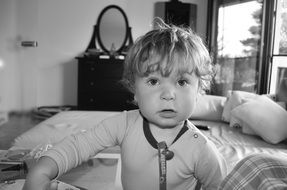 cute baby sitting on the bed