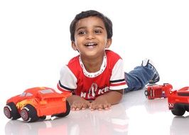 happy boy with toy cars