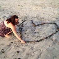 heart of stones in the shape of a heart built by a girl