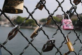 love locks are hung on the railing of the bridge