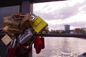 love locks hanged one upon the other on the bridge