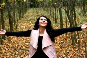 smiling girl on the background of the autumn landscape