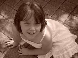little girl in a white dress in monochrome image