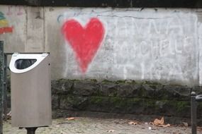 Red heart graffiti on the wall