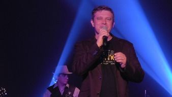 male singer sings on stage