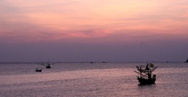 ships on calm water at dusk