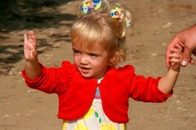 child with blond hair smiles