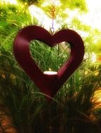 heart and candle in green rays