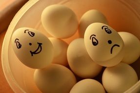 faces are painted on white eggs
