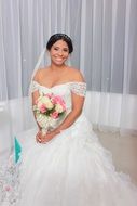 happy bride posing with bouquet