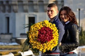 couple in love with a huge bouquet of roses