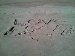 "Love" text drawed on the sand