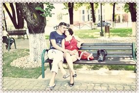 Young couple on the bench in the park