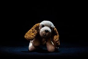 long eared dog, cute soft toy in darkness