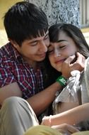happy young boy and girl sitting together