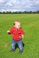 a small child in a red jacket