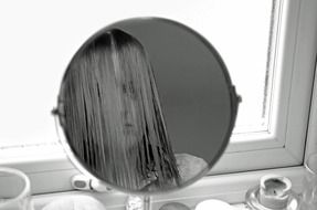 female looking at mirror