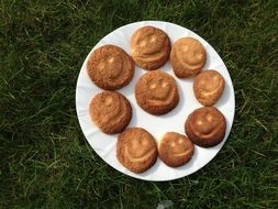 a few cookies with a smiley face on the plate