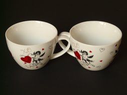 cups in romantic style on a black background