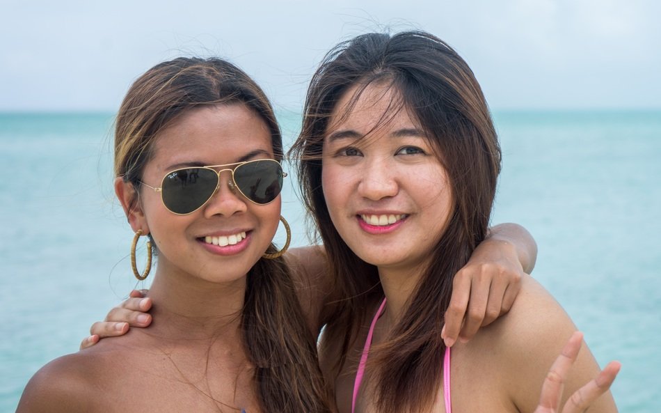 portrait of young women girlfriends on the background of the sea