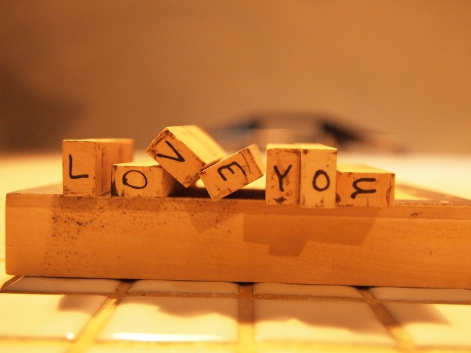 wooden alphabet with the words 'love you'