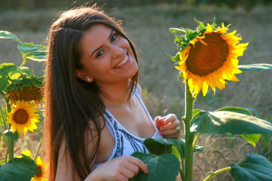 smiling girl on sunflower background