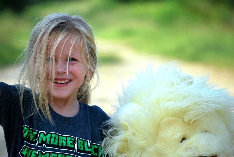 smiling girl with a white teddy bear