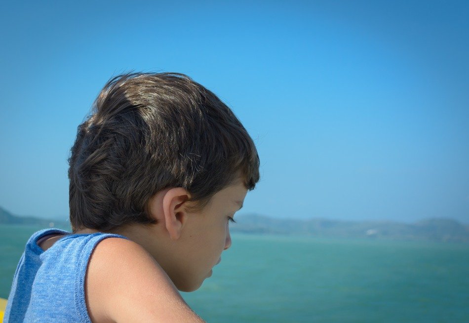 child on emotions near the beach